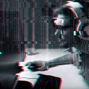 Person wearing headphones sitting at a computer with streams of binary code and glitch effects overlaying the image.